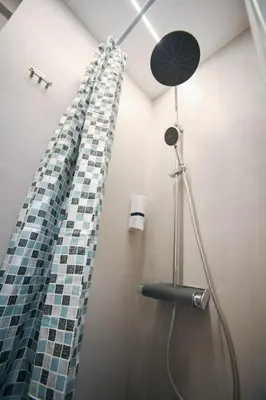a shower with a glass mosaic shower curtain in a bathroom at Evaggelistrias 22 Suite by Zeus Suites in Athens