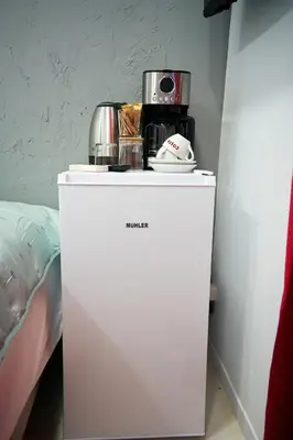 a white refrigerator with a coffee maker on top of it at Evaggelistrias 22 Suite by Zeus Suites in Athens