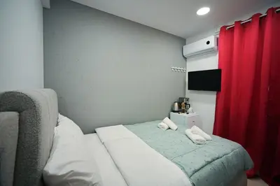 a bedroom with a bed with two towels on it at Evaggelistrias 22 Suite by Zeus Suites in Athens