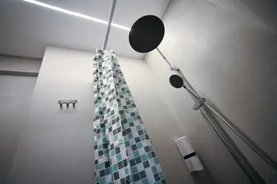 a bathroom with a shower with a shower curtain at Evaggelistrias 22 Suite by Zeus Suites in Athens