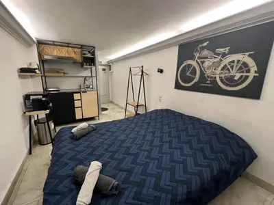 a bedroom with a bed and a picture of a bike on the wall at Athens Center Museum in Athens