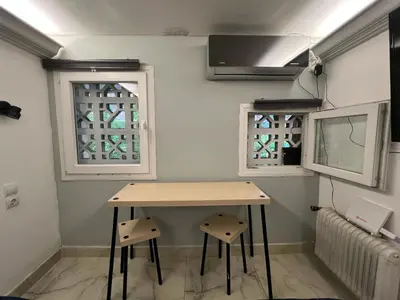 a table and two windows in a room at Athens Center Museum in Athens