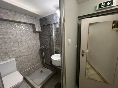a bathroom with a toilet and a sink at Athens Center Museum in Athens