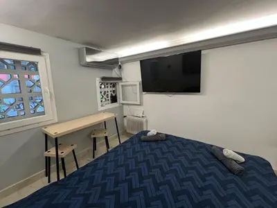 a bedroom with a bed and a desk and a television at Athens Center Museum in Athens