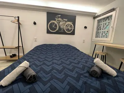 a bedroom with a bed with a bike on the wall at Athens Center Museum in Athens