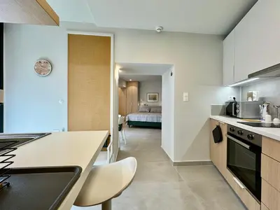 a kitchen with a counter and a room with a bed at AVLI Central Athens Hideaway Walk to All Attractions in Athens