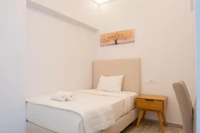 a small bedroom with a bed and a table at Oasis Residence Athens in Athens