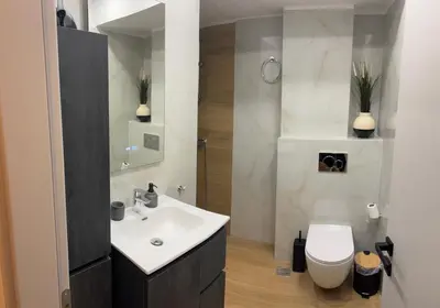 a bathroom with a white sink and a toilet at Evita's cozy Studio Next to Katehaki Metro in Athens