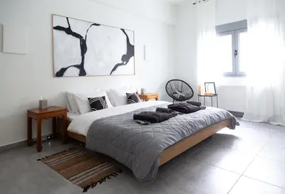 a bedroom with a large bed with towels on it at Central Urban Retreat in Athens