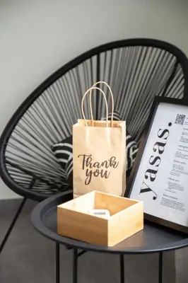 a paper bag sitting on a table with a box at Central Urban Retreat in Athens