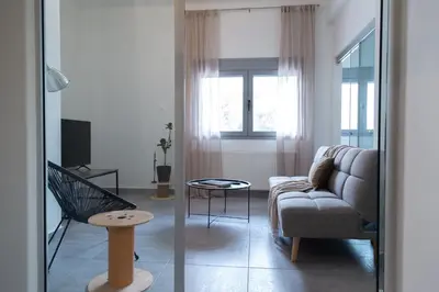 a living room with a couch and a chair at Central Urban Retreat in Athens