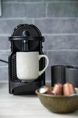 a coffee maker with a cup and a bowl of eggs at Central Urban Retreat in Athens