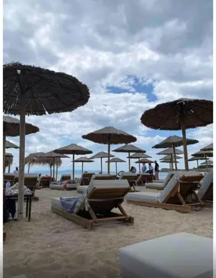 a group of chairs and umbrellas on a beach at Iliana's Retreat by Greece Apartments in Athens