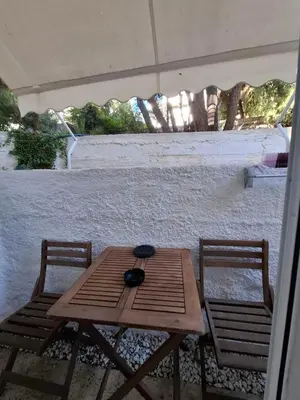 a wooden table and two chairs on a patio at Iliana's Retreat by Greece Apartments in Athens