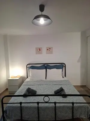 a bedroom with a bed with a lamp on it at Iliana's Retreat by Greece Apartments in Athens