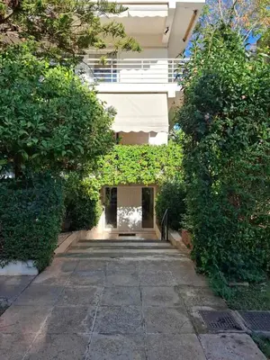 a building with a walkway between two bushes at Iliana's Retreat by Greece Apartments in Athens