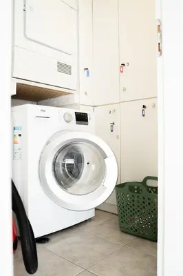 a washer and dryer in a kitchen with a microwave at Elegant Athenian Penthouse in Athens