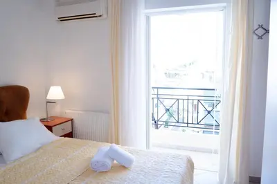 a bedroom with a bed and a large window at Elegant Athenian Penthouse in Athens
