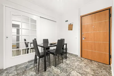 a dining room with a table and chairs and a wooden door at Boho Coastal Retreat with Jacuzzi, 1 min to Beach in Athens