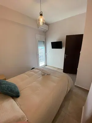 a large bed in a room with a window at Casa del Rey in Piraeus