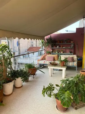 a balcony with a lot of potted plants on it at 7th floor bright penthouse in quiet pedestrian in Athens
