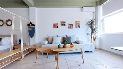 a living room with a couch and a table at Modern comfort and city vibes just steps from Athe in Athens