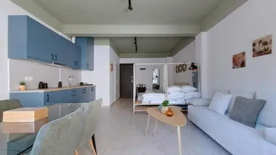 a kitchen and a living room with a couch and a table at Modern comfort and city vibes just steps from Athe in Athens