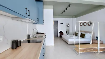 a kitchen with a sink and a bed in a room at Modern comfort and city vibes just steps from Athe in Athens