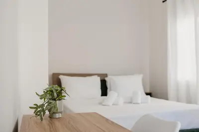 a bedroom with a bed and a table with a plant at Apartment 49 Athens in Athens