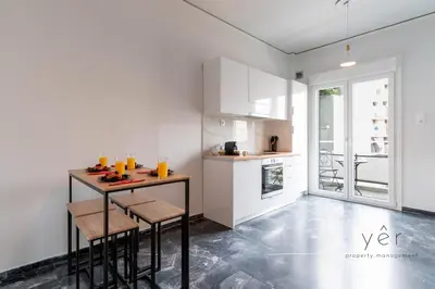 a kitchen with a table with chairs and drinks on it at Elegant & Modern 2BR Apartment - Pireaus Center and Marina in Piraeus