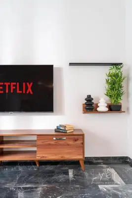 a living room with a tv on a wall at Elegant & Modern 2BR Apartment - Pireaus Center and Marina in Piraeus