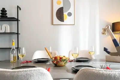 a dining room table with a bowl of fruit and wine glasses at Elegant & Modern 2BR Apartment - Pireaus Center and Marina in Piraeus
