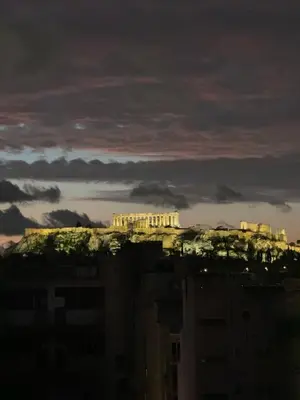 a view of the acropolis from a city at night at Krezias Apartments K1 Acropolis View & Jacuzzi ! in Athens