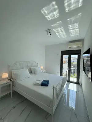 a white bedroom with a white bed and a window at Krezias Apartments ST5 Acropolis View ! in Athens