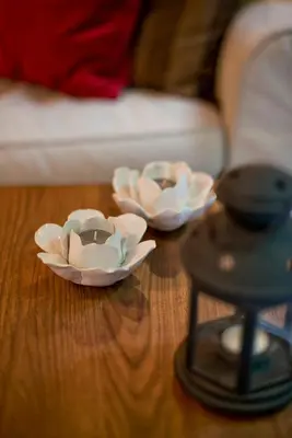two white dishes sitting on a wooden table at Alex Guesthouse Stylish Studio near the Sea in Piraeus
