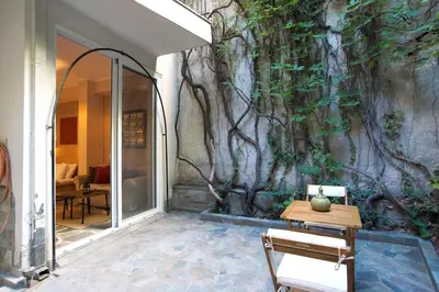 a wall with a tree mural on a building at Alex Guesthouse Stylish Studio near the Sea in Piraeus