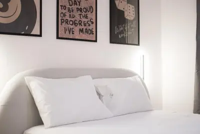 a white couch with a white pillow in a room at Athenian Zen Suite in Athens