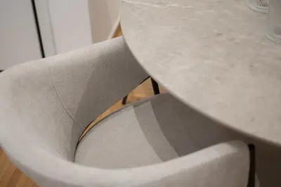 a gray chair sitting next to a table at Athenian Zen Suite in Athens