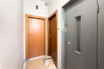 a hallway with two doors and a floor at Athenian Zen Suite in Athens