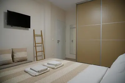 a bedroom with a bed with a sliding glass door at Elegant Athenian Escape near Lycabettus in Athens