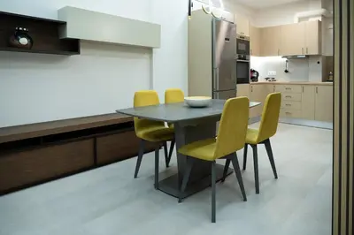 a kitchen with a black table and yellow chairs at Elegant Athenian Escape near Lycabettus in Athens