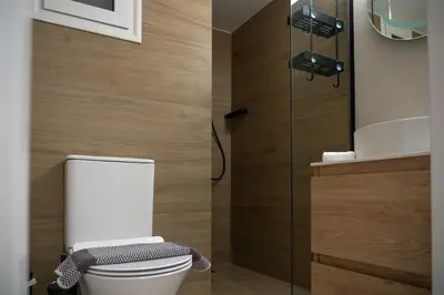 a bathroom with a white toilet and a sink at Elegant Athenian Escape near Lycabettus in Athens