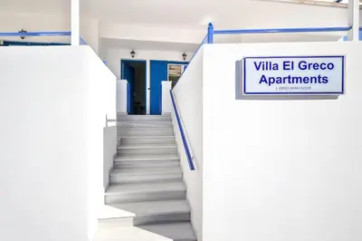 a staircase with a sign that reads ville el greco apartments at Villa El Greco Apartments in Agia Marina Aegina