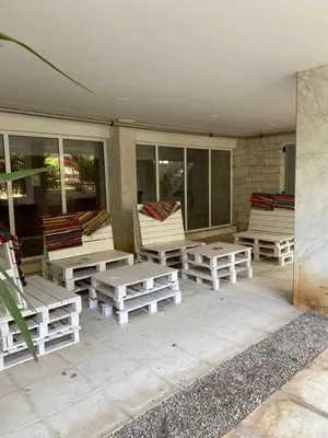 a group of lounge chairs and tables on a patio at Beach side Marina Alimos apartment in Athens