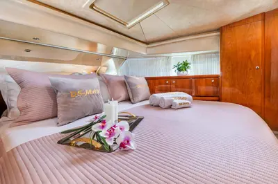 a large bed with a tray of flowers on it at DS MAI Sailing in Athens