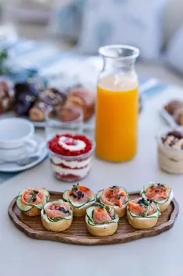 a plate of pastries on a table with orange juice at DS MAI Sailing in Athens
