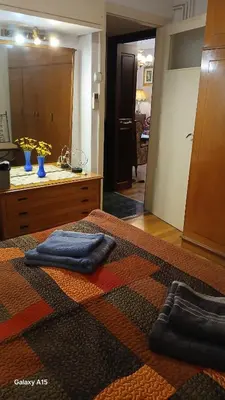 a bathroom with two blue towels on a bed at Cozy Classic Residence 