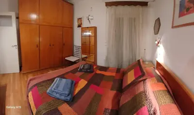 a bedroom with a bed with two bags on it at Cozy Classic Residence 