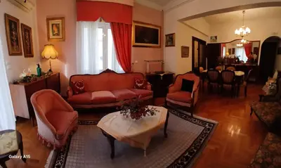 a living room with red furniture and a table at Cozy Classic Residence 