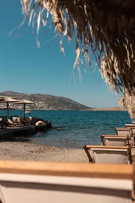 a group of chairs on a beach with the ocean at Kiani Akti in Porto Rafti